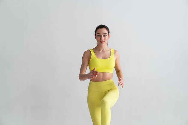 Young fitness woman In sportswear jumping on sport trampoline