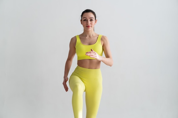 Young fitness woman In sportswear jumping on sport trampoline