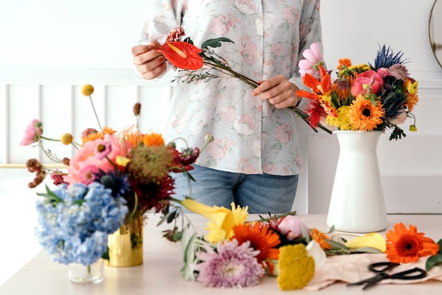 Young florist making a beautiful flower arrangement