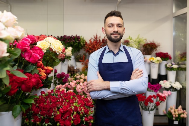 Young florist professional in the refrigerator with fresh flowers