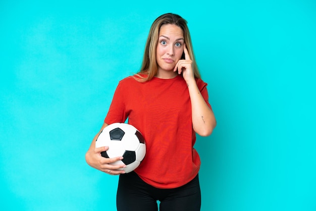 Young football player woman isolated on blue background thinking an idea