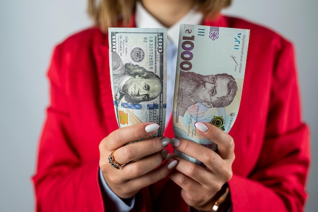 young fragile hands of a woman hold a fan with thousands of hryvnias money of Ukraine a wealthy woman hryvnias in hands