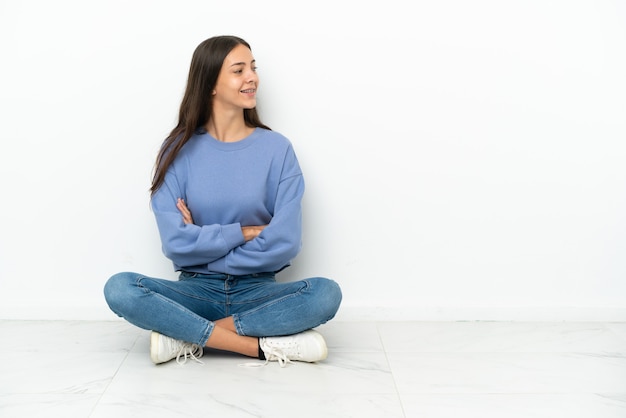 Young French girl sitting on the floor in lateral position