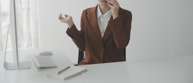 Young friendly operator woman agent with headsets working in a call centre