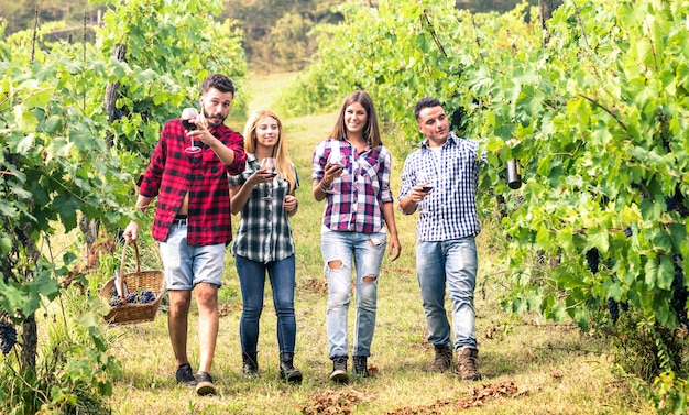 Young friends having fun walking at winery vineyard outdoors