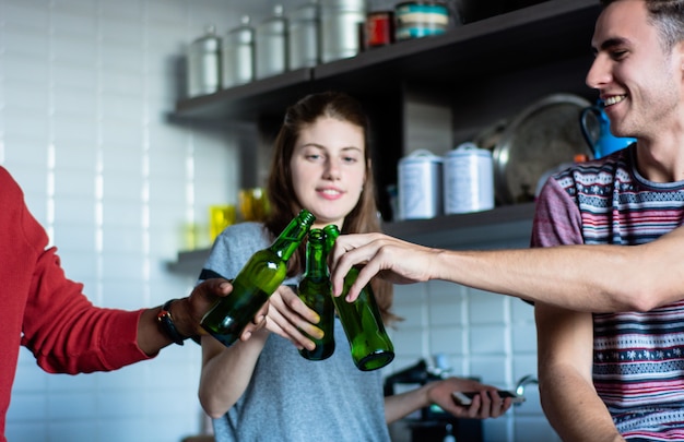 Young friends having fun with bottles at home.