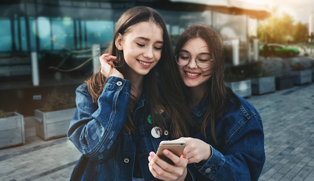 Young friends having fun with smartphone in spring day