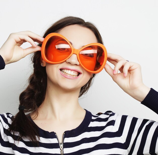 young funny woman with big orange sunglasses