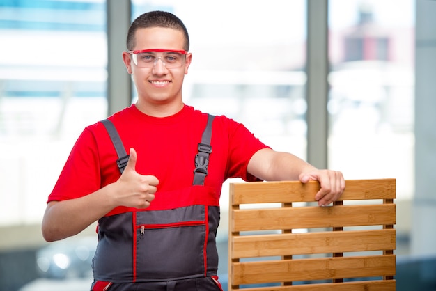 Young furniture carpenter in industrial 