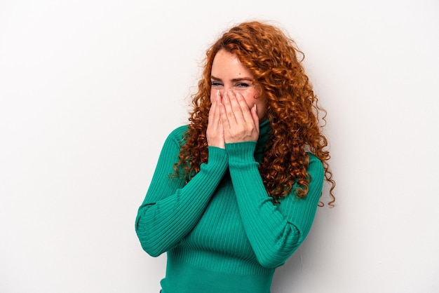 Young ginger caucasian woman isolated on white background laughing about something covering mouth with hands