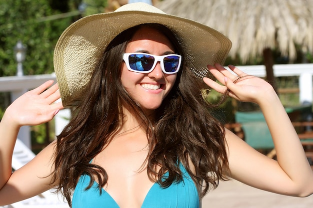 Young girl in beautiful bikini near swimming pool