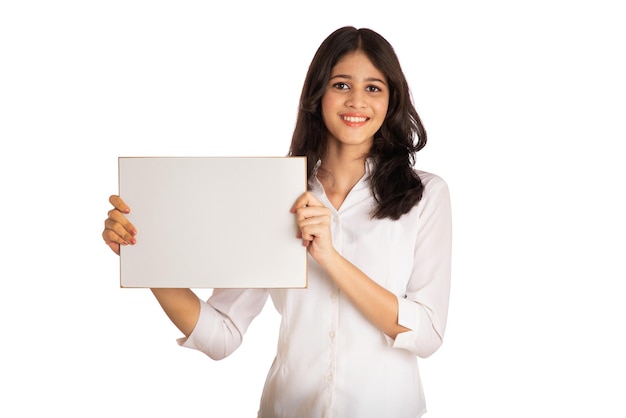 A young girl or businesswoman holding a signboard in her hands on a white background