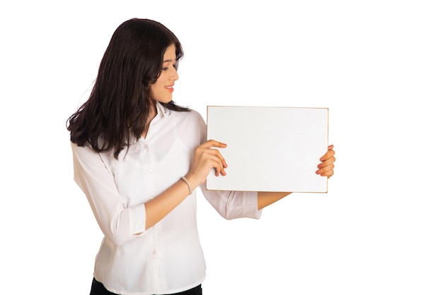 A young girl or businesswoman holding a signboard in her hands on a white background