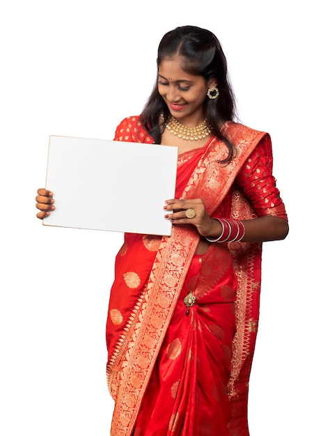 A young girl or businesswoman wearing a saree and holding a signboard in her hands on a white background