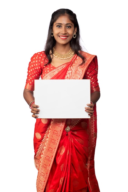 A young girl or businesswoman wearing a saree and holding a signboard in her hands on a white background