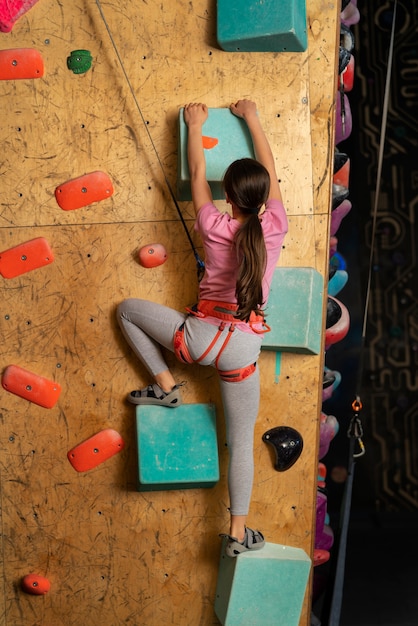 Young girl climbing indoors at the arena