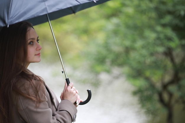 Young girl in a coat in a spring park