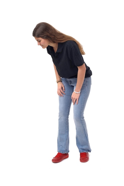 Young girl crouching and looking the floor on white background