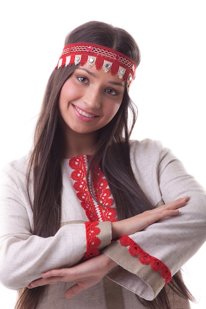 Young girl in dance pose - flax traditional russian costume