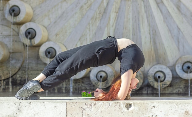 young girl doing exercise in the city woman doing yoga exercise person doing stretching