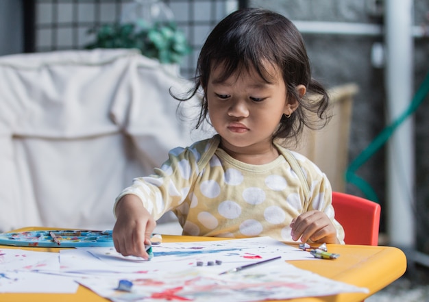 Young girl drawing and painting