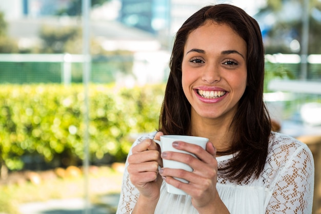 Young girl drink her tea and smiling