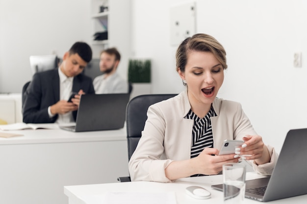 A young girl employee of a Bank or insurance company is bored and yawns at the workplace. office routine.