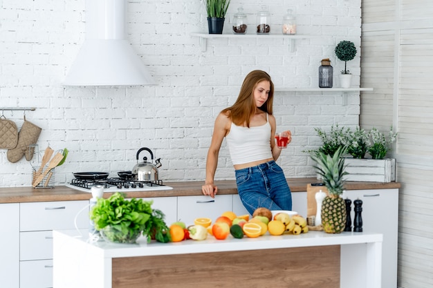 young girl enjoying a beverage in the kitchen