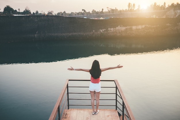 Young girl enjoying sunset on the balcony