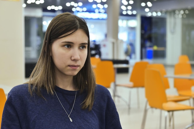 A young girl in the food court of a shopping center