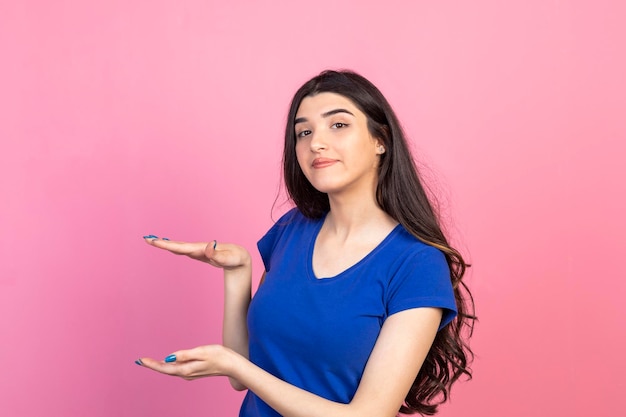 Young girl gesturing measure with her hands High quality photo