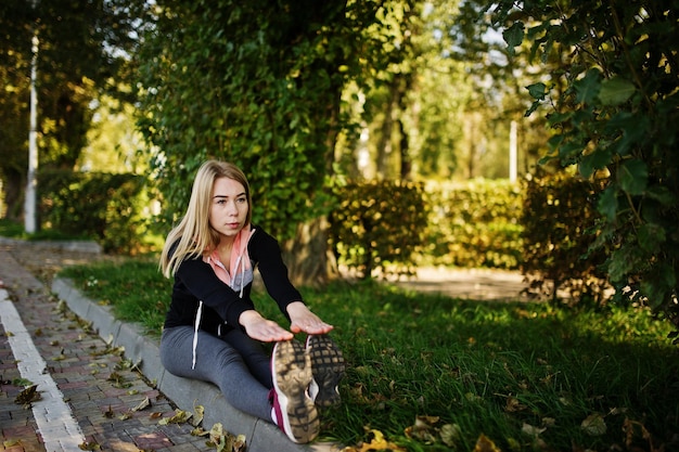 Young girl has the training and doing exercise outdoors Sport fitness street workout concept