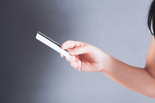 Young girl holding a bank card in her hand