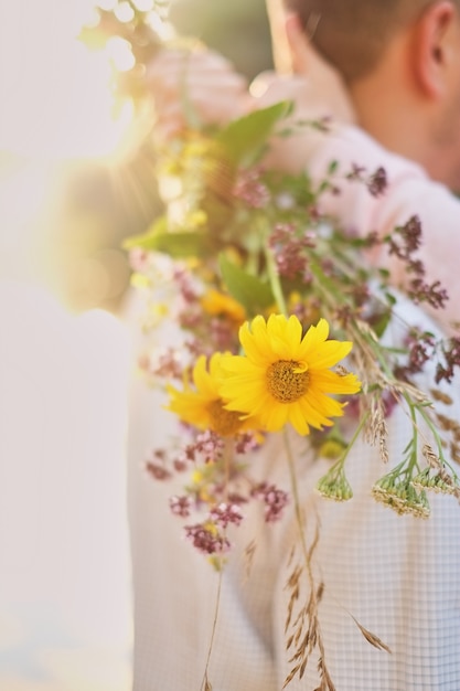 Young girl holding a bouquet of wildflowers in hands