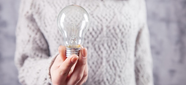 Young girl holding a light bulb