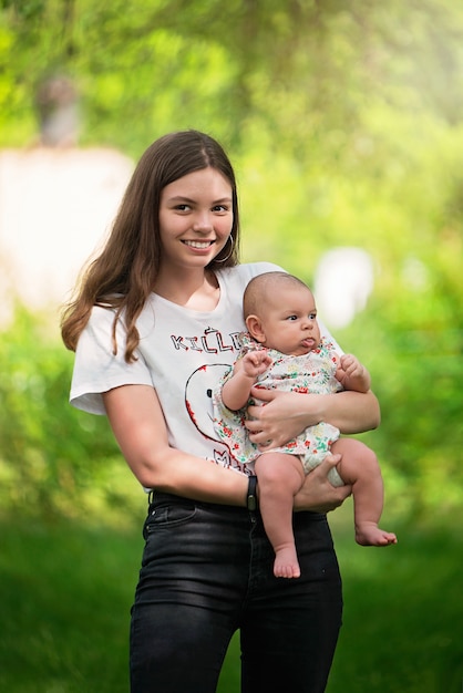 Young girl holding a newborn baby