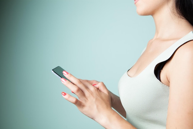 A young girl holding a phone in her hands