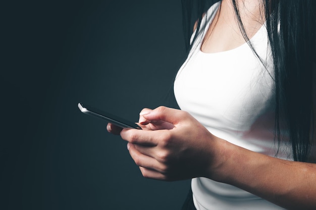 A young girl holding a phone in her hands