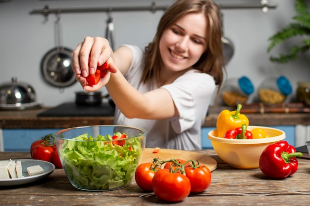 Young girl is preparing a salad