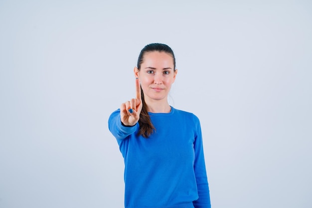 Young girl is showing a minute getsure on white background