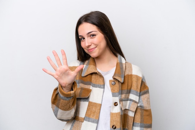 Young girl isolated on white background counting five with fingers