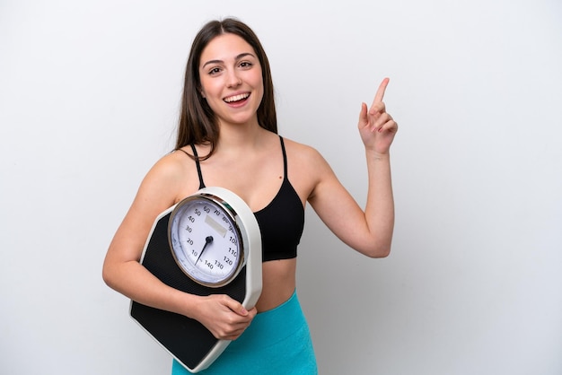 Young girl isolated on white background with weighing machine