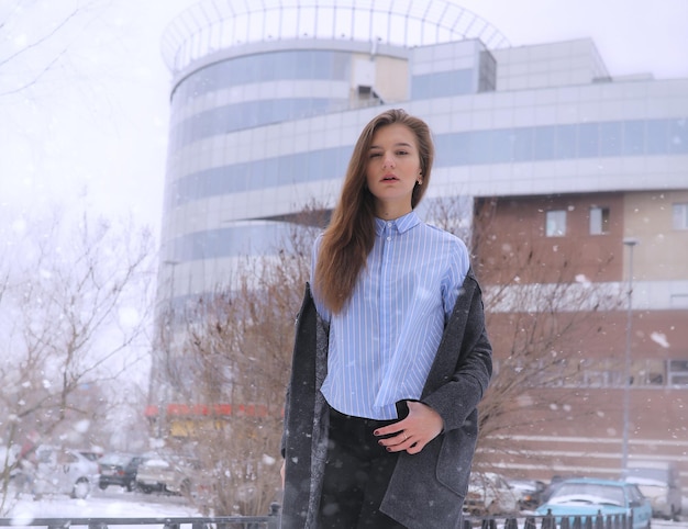 Young girl outdoors in winter. Model girl posing outdoors on a winter day. Festive weekend in the street walking girl.