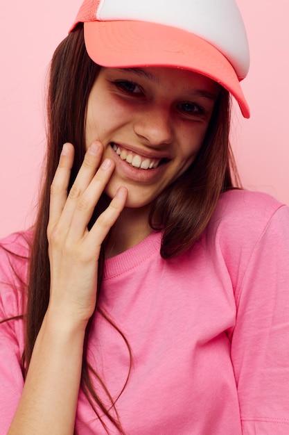 Young girl in a pink tshirt with a cap on her head casual wear