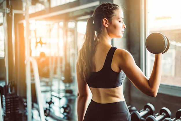 Young girl playing dumbbell