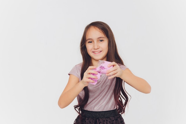 Young girl playing with slime. Isolated on white background.