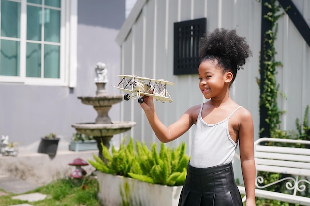 Young girl playing with toy airplane