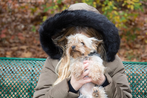 young girl portrait behin a small dog portrait fun outdoor winter