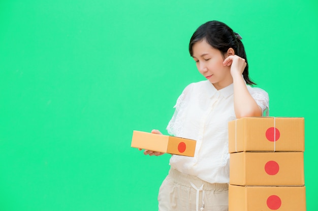 young girl prepare parcel box for delivery,