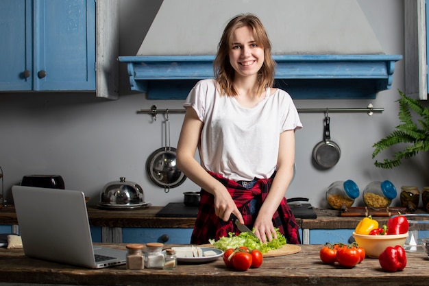 Young girl preparing vegetarian salad